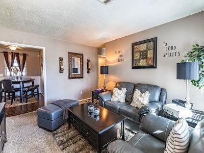 living room with a textured ceiling