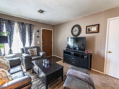 living room featuring carpet and a textured ceiling