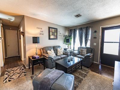 living room with dark hardwood / wood-style flooring, plenty of natural light, and a textured ceiling