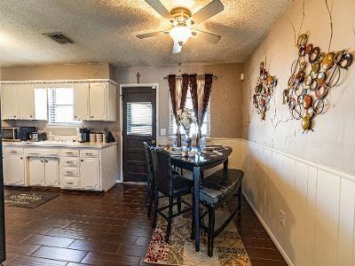 dining space with ceiling fan, dark hardwood / wood-style floors, and a textured ceiling