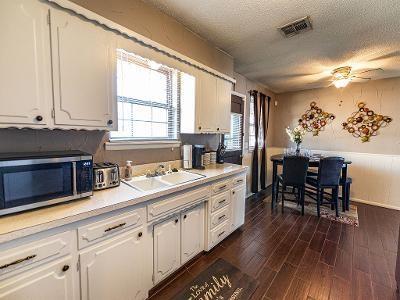 kitchen with sink, white cabinets, dark hardwood / wood-style flooring, ceiling fan, and a textured ceiling