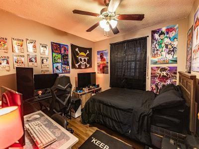 bedroom with wood-type flooring, ceiling fan, and a textured ceiling