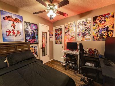 bedroom with wood-type flooring, ceiling fan, and a textured ceiling