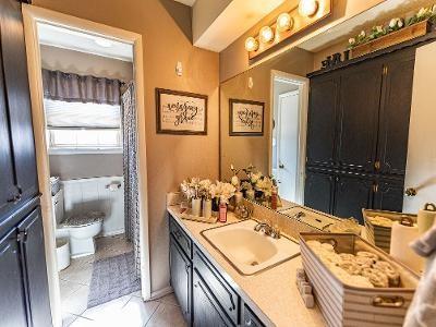 bathroom featuring tile patterned floors, vanity, and toilet