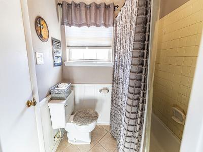 bathroom with tile patterned flooring, toilet, and a shower with shower curtain