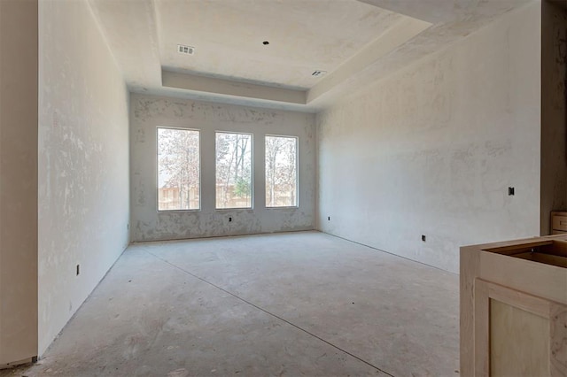 unfurnished room with a tray ceiling