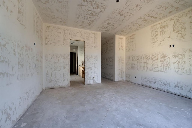 unfurnished room featuring concrete flooring