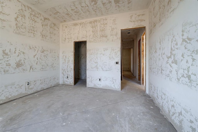 unfurnished room featuring concrete flooring