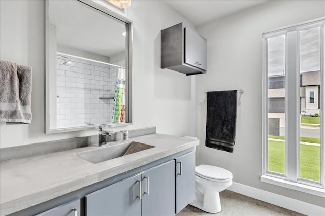 bathroom with vanity, curtained shower, and toilet