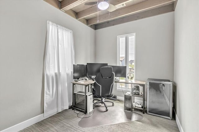 carpeted office with ceiling fan and beamed ceiling