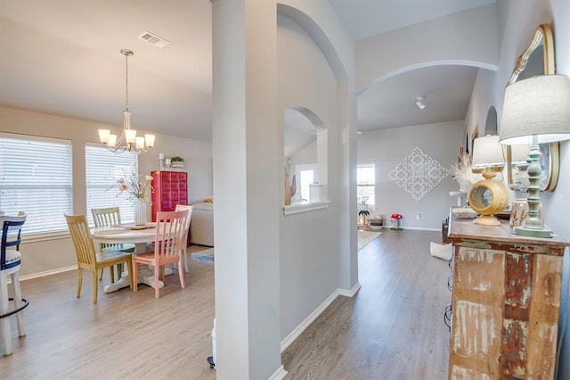 interior space with an inviting chandelier and hardwood / wood-style floors