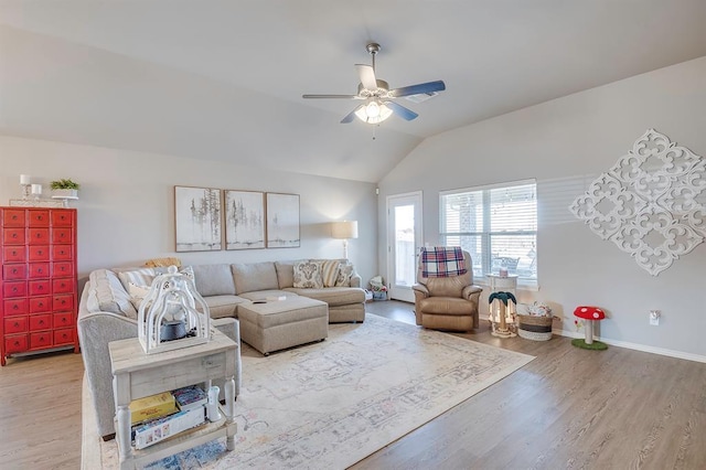 living room featuring vaulted ceiling, light hardwood / wood-style floors, and ceiling fan