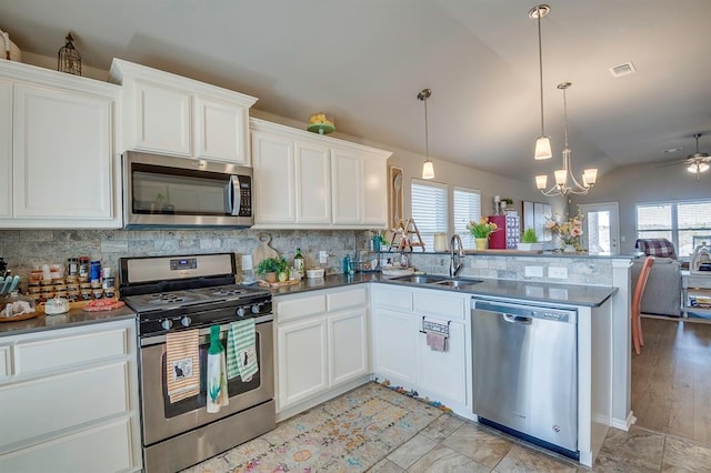 kitchen with white cabinetry, stainless steel appliances, and sink