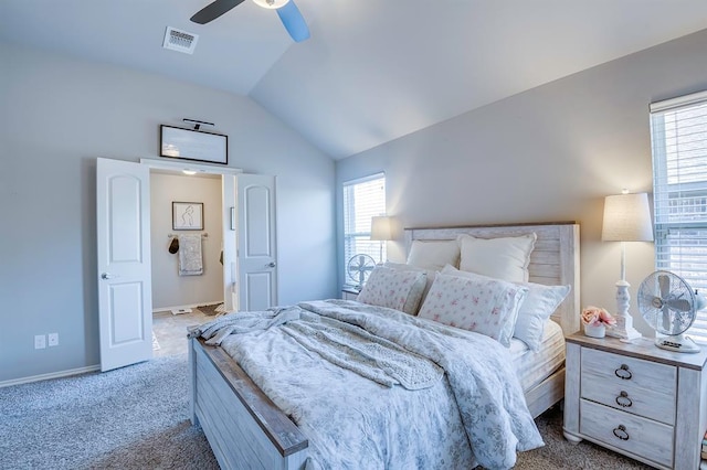 bedroom with multiple windows, ceiling fan, vaulted ceiling, and light carpet