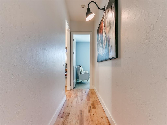 corridor with light hardwood / wood-style floors