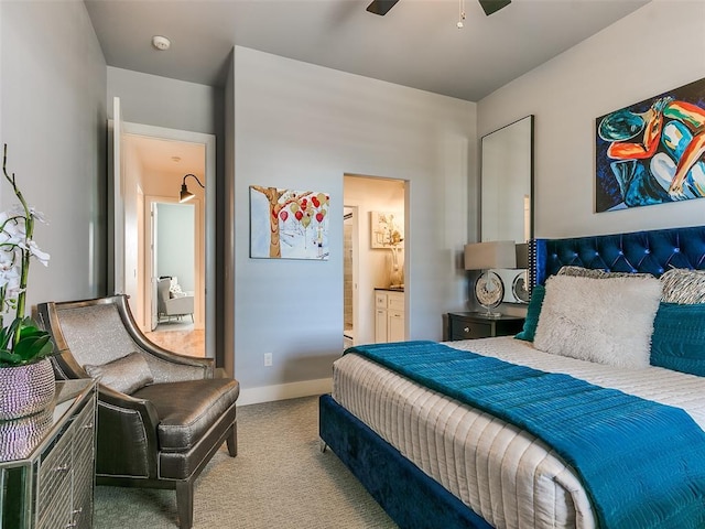 bedroom featuring connected bathroom and light carpet