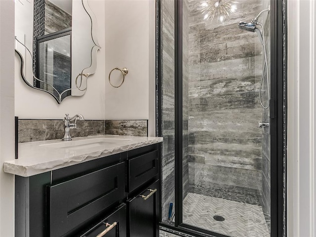 bathroom with vanity and tiled shower