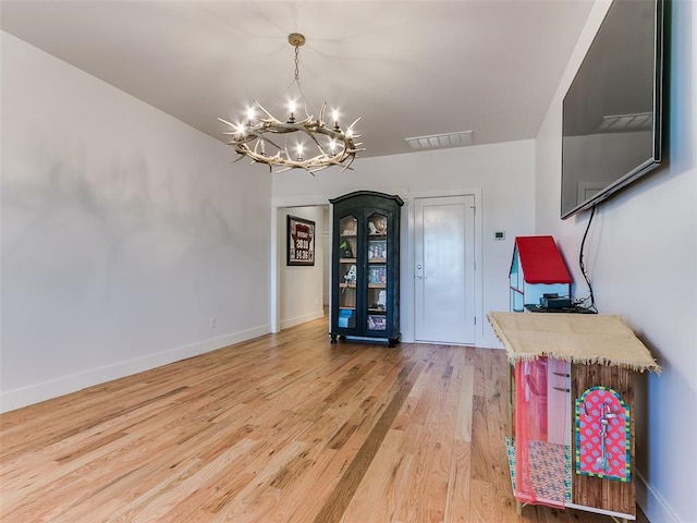 interior space with an inviting chandelier and wood-type flooring