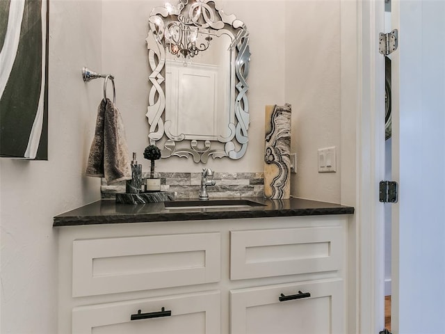 bathroom with vanity and an inviting chandelier