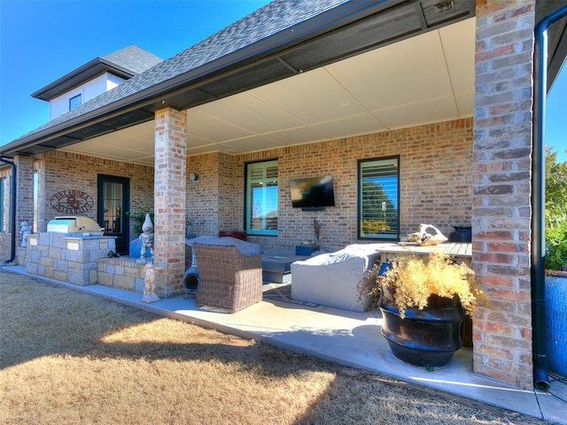 view of patio / terrace with an outdoor living space, an outdoor kitchen, and a bar