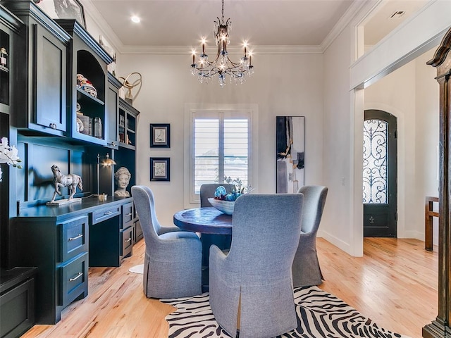 dining room featuring a notable chandelier, crown molding, and light hardwood / wood-style floors