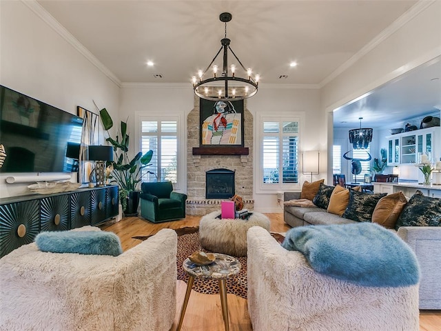 living room with plenty of natural light, ornamental molding, and light wood-type flooring