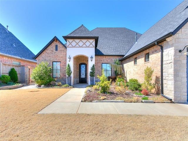 3208 Rolling Woods Dr, Norman, OK 73072 - tudor home with brick siding and a shingled roof