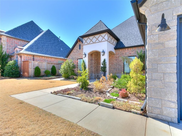 3208 Rolling Woods Dr, Norman, OK 73072 - english style home with fence, brick siding, and roof with shingles