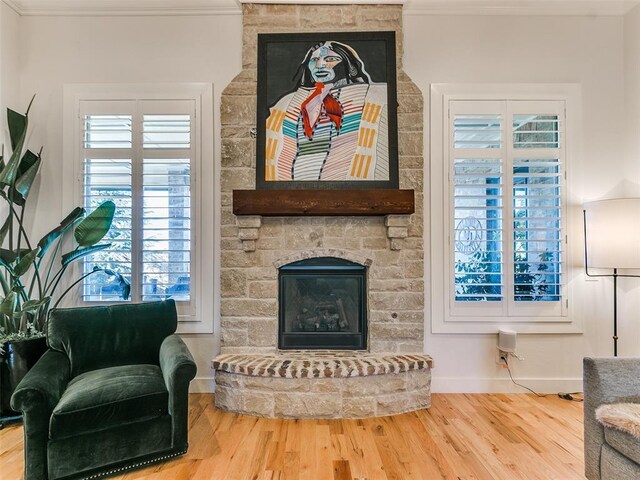 3208 Rolling Woods Dr, Norman, OK 73072 - living area featuring baseboards, a stone fireplace, wood finished floors, and ornamental molding