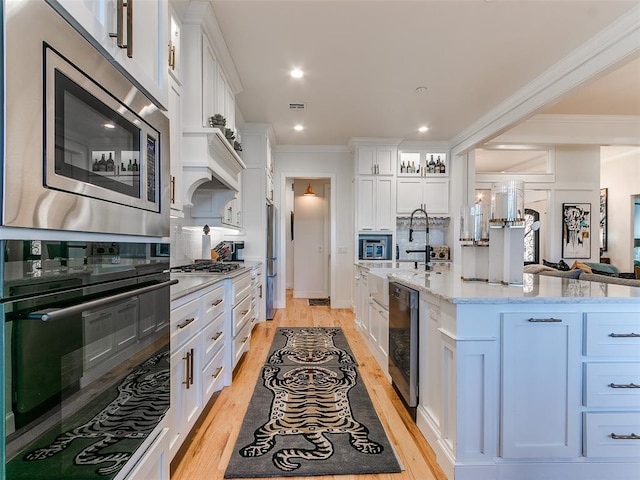 3208 Rolling Woods Dr, Norman, OK 73072 - kitchen with beverage cooler, light stone counters, appliances with stainless steel finishes, white cabinets, and decorative backsplash