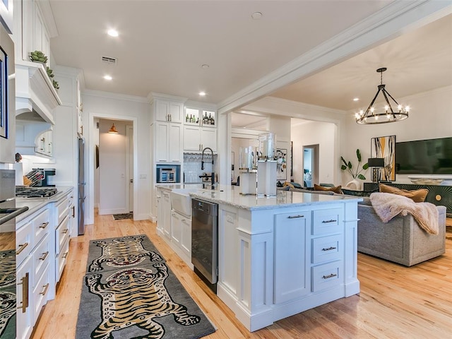 3208 Rolling Woods Dr, Norman, OK 73072 - kitchen with visible vents, crown molding, open floor plan, light wood-style flooring, and white cabinets