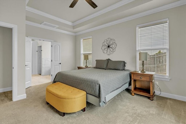 carpeted bedroom with ceiling fan, ornamental molding, and a raised ceiling