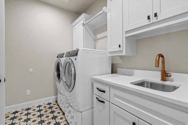 laundry area featuring cabinets, sink, and washing machine and clothes dryer