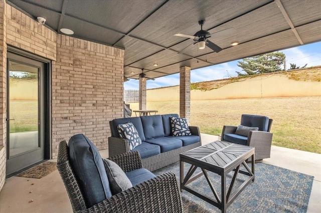 view of patio / terrace with ceiling fan and an outdoor living space