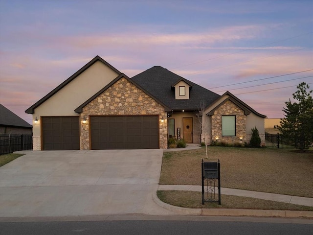 view of front of property with a yard and a garage