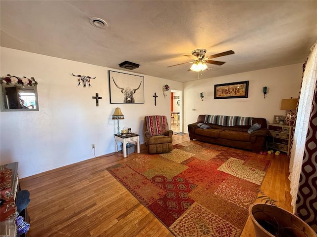 living room with hardwood / wood-style flooring and ceiling fan