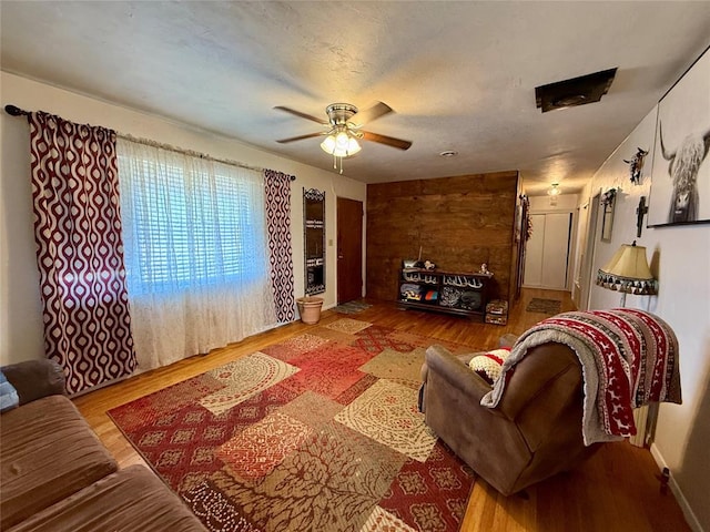 living room with ceiling fan and light hardwood / wood-style flooring