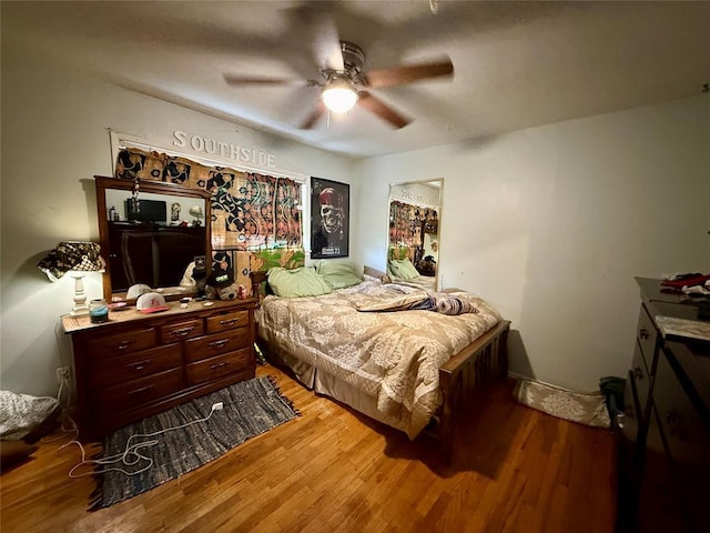 bedroom featuring wood-type flooring and ceiling fan