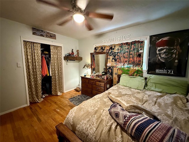 bedroom with hardwood / wood-style floors, ceiling fan, and a closet