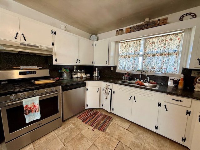 kitchen with white cabinetry, appliances with stainless steel finishes, sink, and tasteful backsplash