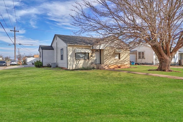 view of front of property with cooling unit and a front yard