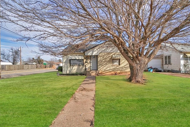 view of front of property with a garage and a front yard