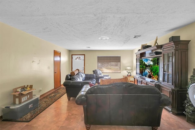 tiled living room featuring a textured ceiling