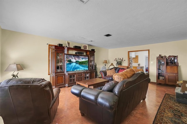 tiled living room featuring a textured ceiling