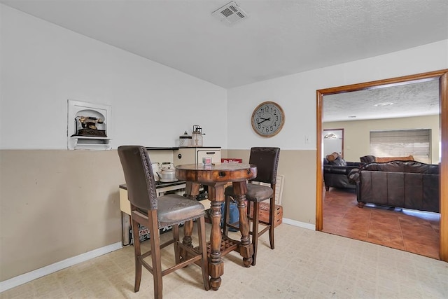 dining room featuring a textured ceiling