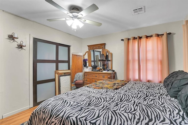 bedroom with hardwood / wood-style flooring and ceiling fan