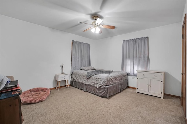 bedroom featuring ceiling fan and light carpet