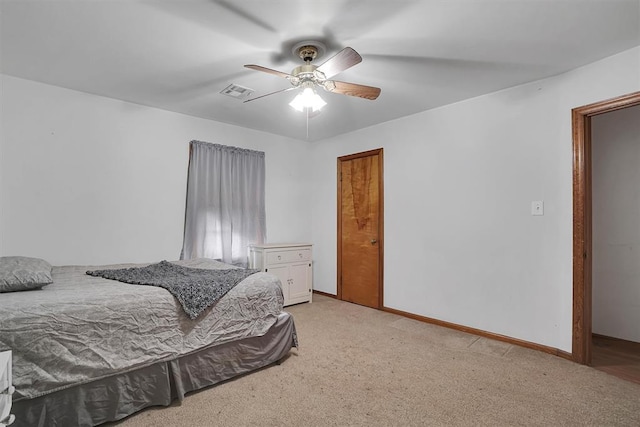 bedroom with ceiling fan and light carpet