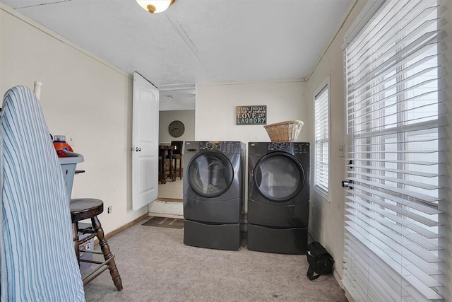 washroom with washer and clothes dryer and light carpet