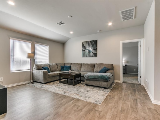 living room with lofted ceiling and light wood-type flooring